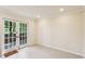 Living room with double french doors leading to the outdoor space at 104 Verlaine Nw Pl, Atlanta, GA 30327