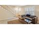 Bright living room with hardwood floors, white trim, and neutral furniture creating a warm and inviting atmosphere at 104 Verlaine Nw Pl, Atlanta, GA 30327
