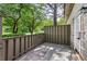 Private patio with stone floor, wood fence, and access to the lush green backyard at 104 Verlaine Nw Pl, Atlanta, GA 30327