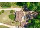 An aerial view showcases the lush landscaping, pool, and meticulous design of the home's exterior and surroundings at 112 Pebblebrooke Run, Canton, GA 30115