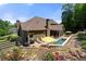 Charming home featuring a patio with an in-ground pool and beautifully landscaped backyard with colorful flowers at 112 Pebblebrooke Run, Canton, GA 30115
