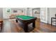 Finished basement with a pool table, luxury vinyl flooring, couch, and natural light from a window at 112 Pebblebrooke Run, Canton, GA 30115
