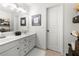 Bathroom with a white dual sink vanity, framed mirror, tile floors, decor, and neutral wall color at 112 Pebblebrooke Run, Canton, GA 30115