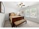 Comfortable bedroom with natural light, ceiling fan, bench, and neutral colors for a relaxing atmosphere at 112 Pebblebrooke Run, Canton, GA 30115
