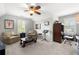 Inviting bonus room with neutral paint, ceiling fan, two windows, furnishings, and decor, perfect for flexible living at 112 Pebblebrooke Run, Canton, GA 30115