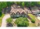 A stunning home exterior with a well-manicured lawn, mature trees, and a welcoming driveway at 112 Pebblebrooke Run, Canton, GA 30115