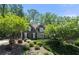 Charming two-story home with mature trees and professional landscaping enhancing curb appeal at 112 Pebblebrooke Run, Canton, GA 30115