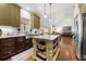 Open kitchen with island, stainless appliances and granite countertops at 112 Pebblebrooke Run, Canton, GA 30115