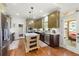 Bright kitchen boasts stainless steel appliances, a large island, and olive-tone cabinets with white countertops at 112 Pebblebrooke Run, Canton, GA 30115