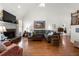 Cozy living room with a stone fireplace, perfect for relaxing and entertaining guests at 112 Pebblebrooke Run, Canton, GA 30115