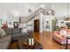 Open-concept living room with hardwood floors and a soaring ceiling filled with natural light at 112 Pebblebrooke Run, Canton, GA 30115