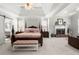 Spacious main bedroom with tray ceiling, a fireplace, and a four-poster bed at 112 Pebblebrooke Run, Canton, GA 30115