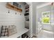 Functional mudroom with hooks, shelf, bench, storage, and laundry area for easy organization at 112 Pebblebrooke Run, Canton, GA 30115