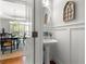 Elegant powder room featuring a pedestal sink, framed mirror, sconces, decorative paneling, and hardwood floors at 112 Pebblebrooke Run, Canton, GA 30115