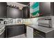 Galley kitchen featuring black cabinetry, stainless steel appliances, and a modern sink at 130 26Th St # 706, Atlanta, GA 30309