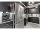 Modern kitchen with stainless steel appliances, sleek black cabinets, and marbled countertops at 130 26Th St # 706, Atlanta, GA 30309