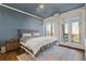 Comfortable bedroom with large windows and a door to the balcony allowing natural light and outside views at 130 26Th St # 706, Atlanta, GA 30309