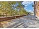 Outdoor patio with brick accents and views of the surrounding trees at 130 26Th St # 706, Atlanta, GA 30309