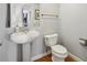 Bathroom featuring pedestal sink, toilet, and mirror with a view into another room at 238 Walker # 39, Atlanta, GA 30313