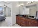 Bathroom featuring double sinks with wood cabinets, large mirror, and view to the bedroom at 238 Walker # 39, Atlanta, GA 30313