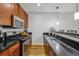 Kitchen featuring a stainless steel range and microwave paired with dark countertops and wood cabinets at 238 Walker # 39, Atlanta, GA 30313