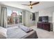 Bedroom featuring neutral carpet, ceiling fan, large window, and dresser for ample storage at 238 Walker # 39, Atlanta, GA 30313
