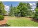 Spacious backyard with a trampoline and mature trees, perfect for outdoor activities at 4891 Tarry Post Ln, Suwanee, GA 30024