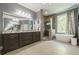 Well-lit bathroom with a soaking tub, glass enclosed shower, and double sink vanity at 4891 Tarry Post Ln, Suwanee, GA 30024