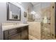 Bathroom featuring a marble vanity and seamless glass shower with tile surround and checkered shower floor at 4891 Tarry Post Ln, Suwanee, GA 30024