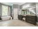 Bright bathroom with a soaking tub, granite countertops, and a view of the outdoors at 4891 Tarry Post Ln, Suwanee, GA 30024
