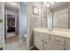Bright bathroom featuring tiled floor, white vanity, shower, and calming lavender walls at 4891 Tarry Post Ln, Suwanee, GA 30024