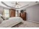 Neutral bedroom features carpet, dresser and television, a bed with a white comforter, and soothing grey walls at 4891 Tarry Post Ln, Suwanee, GA 30024
