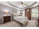 Neutral bedroom features carpet, dresser and closet, a bed with a white comforter, and soothing grey walls at 4891 Tarry Post Ln, Suwanee, GA 30024
