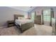 Bedroom featuring carpet, stylish grey walls, and three windows with ample natural light at 4891 Tarry Post Ln, Suwanee, GA 30024