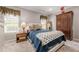 Bedroom featuring a large bed, neutral walls, bedside table and ample closet space at 4891 Tarry Post Ln, Suwanee, GA 30024