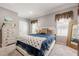 Cozy bedroom with neutral walls, plush carpet, large windows and ample closet space at 4891 Tarry Post Ln, Suwanee, GA 30024