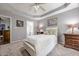 Neutral bedroom features carpet, a bed with a white comforter, and soothing grey walls at 4891 Tarry Post Ln, Suwanee, GA 30024