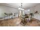 Open dining area with stylish tile flooring, seating, and a view into the living area at 4891 Tarry Post Ln, Suwanee, GA 30024