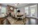 Elegant dining room featuring a stone fireplace, hardwood floors, and a large dining table at 4891 Tarry Post Ln, Suwanee, GA 30024