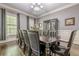 Formal dining room with seating for 10 under a chandelier, with windows for natural light at 4891 Tarry Post Ln, Suwanee, GA 30024