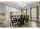 Formal dining room with dark wood flooring, chandelier, and large windows, perfect for entertaining at 4891 Tarry Post Ln, Suwanee, GA 30024