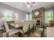 Cozy dining area featuring a stone fireplace, hardwood floors, and ample natural light at 4891 Tarry Post Ln, Suwanee, GA 30024
