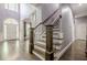 Grand foyer with hardwood floors, staircase, transom window and elegant front door at 4891 Tarry Post Ln, Suwanee, GA 30024