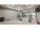 Large home gym with mirrors, carpet flooring, exercise equipment and adjacent bedroom at 4891 Tarry Post Ln, Suwanee, GA 30024