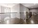Upstairs hallway with dark wood floors and iron railing at 4891 Tarry Post Ln, Suwanee, GA 30024