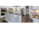 Bright kitchen featuring stainless steel appliances, an island, and white cabinets at 4891 Tarry Post Ln, Suwanee, GA 30024