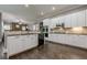 Bright kitchen with white cabinets and stainless appliances, open to dining area at 4891 Tarry Post Ln, Suwanee, GA 30024