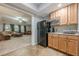 Features a convenient kitchenette area with wood cabinets and full-size appliances, next to the living room at 4891 Tarry Post Ln, Suwanee, GA 30024