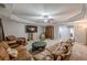 Spacious living room features carpet flooring, tray ceiling and comfortable furnishings at 4891 Tarry Post Ln, Suwanee, GA 30024