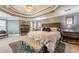 Spacious main bedroom with a luxurious bed, coffered ceiling, and stylish decor at 4891 Tarry Post Ln, Suwanee, GA 30024